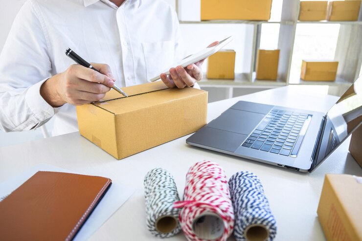 midsection-man-working-office-with-laptop-cardboard-box-table_1048944-28855106