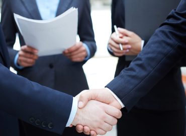 Close-up of businessmen handshaking in working environment