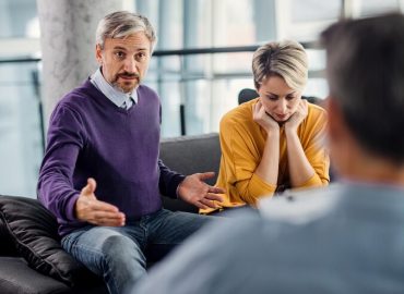 mid-adult-man-talking-marriage-counselor-while-being-with-his-wife-couple-therapy_637285-11110